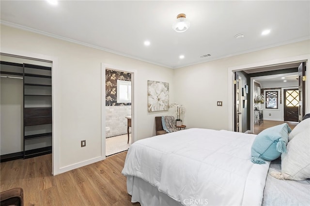 bedroom featuring hardwood / wood-style floors, a closet, and crown molding