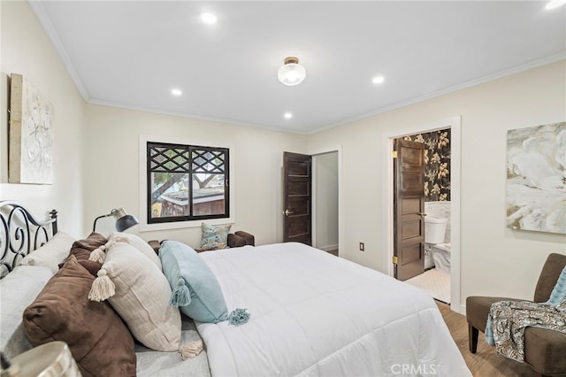 bedroom with ornamental molding, connected bathroom, and hardwood / wood-style floors