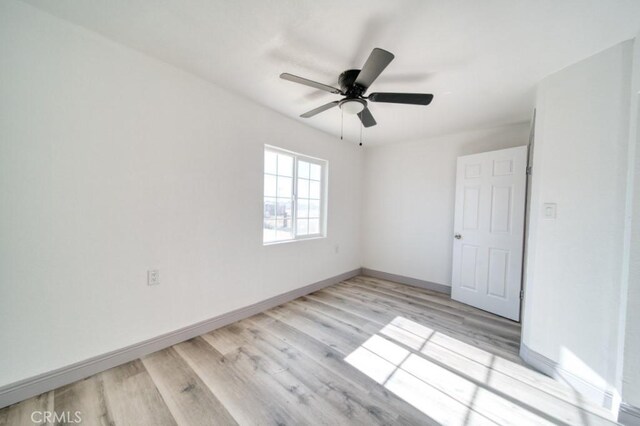 empty room featuring light wood-type flooring and ceiling fan