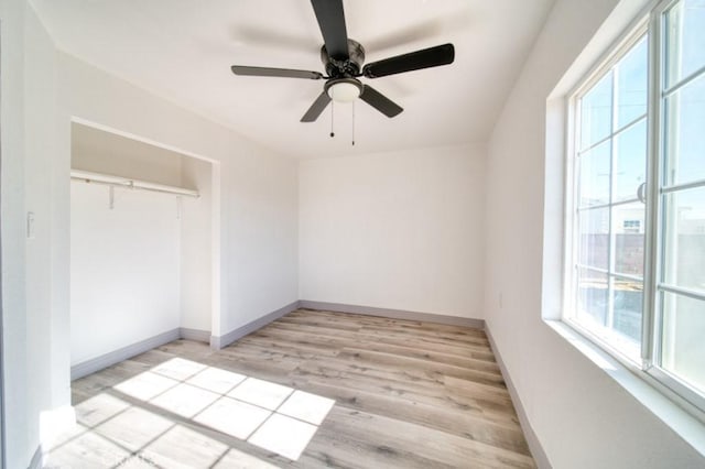 empty room featuring ceiling fan and light hardwood / wood-style flooring