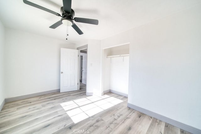 unfurnished bedroom with ceiling fan, a closet, and light wood-type flooring