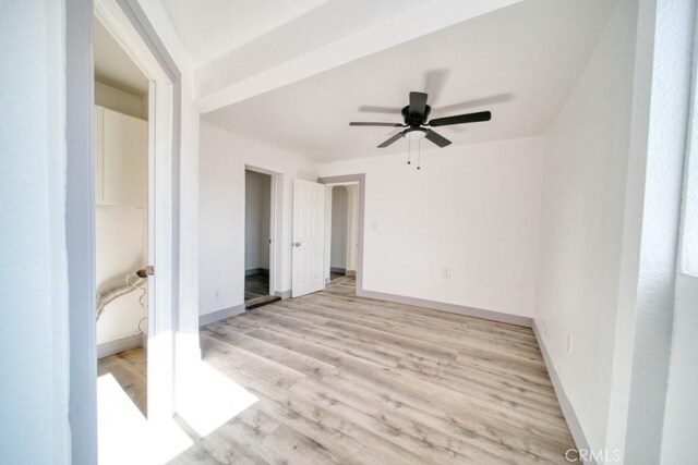 empty room featuring ceiling fan and light wood-type flooring