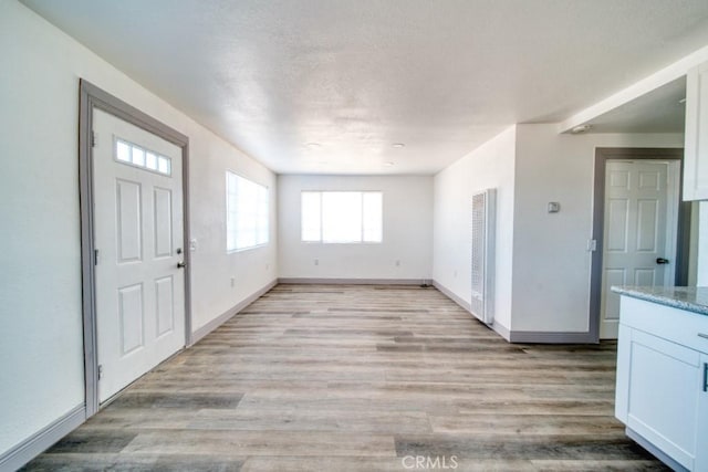 foyer entrance with light wood-type flooring