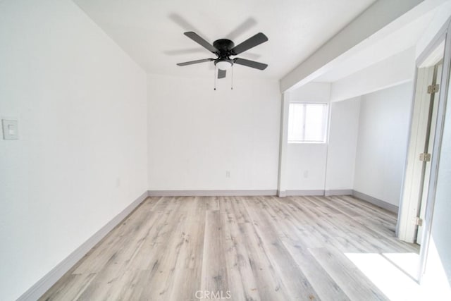 spare room with light wood-type flooring and ceiling fan