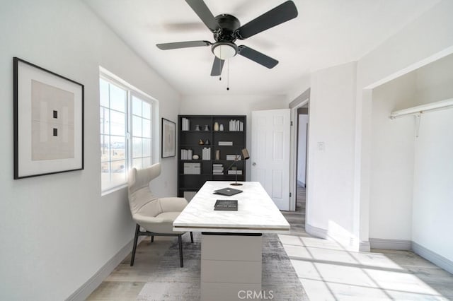 office space with light wood-type flooring and ceiling fan