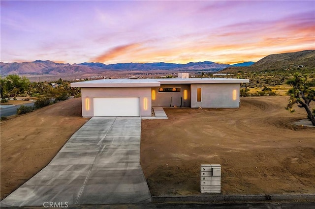 view of front of home featuring a mountain view and a garage