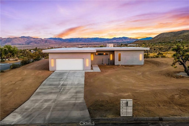 view of front of property with a garage and a mountain view