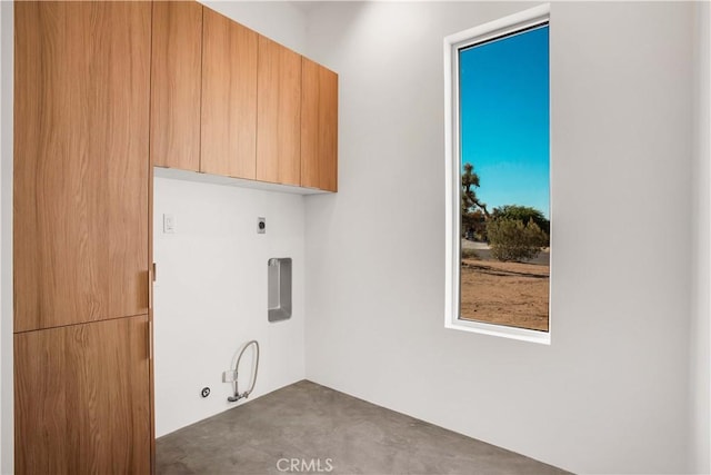 laundry room featuring cabinets, hookup for a gas dryer, and hookup for an electric dryer