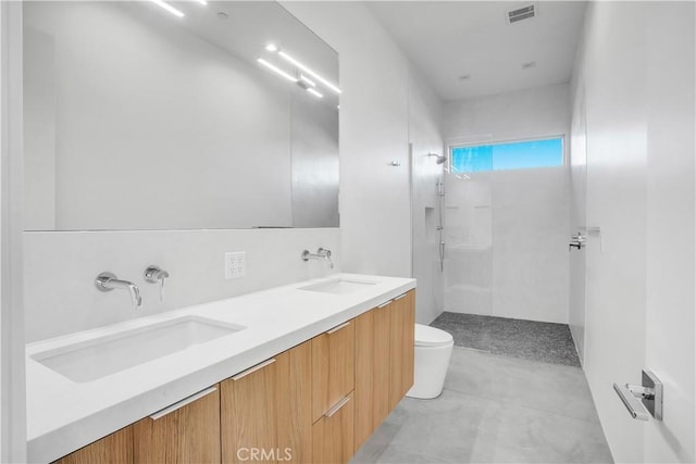 bathroom featuring toilet, a shower, decorative backsplash, and vanity