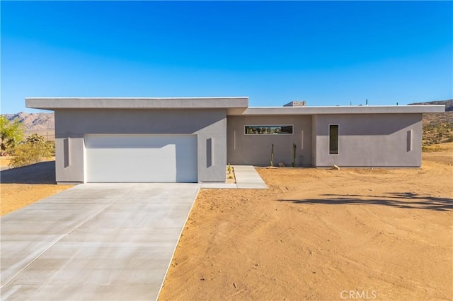 view of front of house featuring a mountain view and a garage