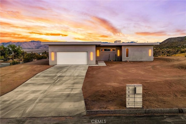 view of front of house featuring a mountain view and a garage