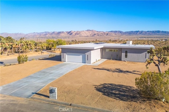 view of front of property with a mountain view and a garage