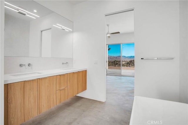 bathroom with ceiling fan, concrete flooring, and vanity