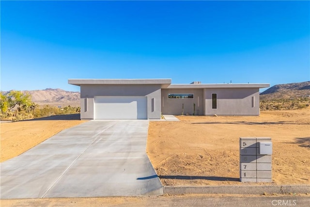 view of front facade featuring a garage and a mountain view