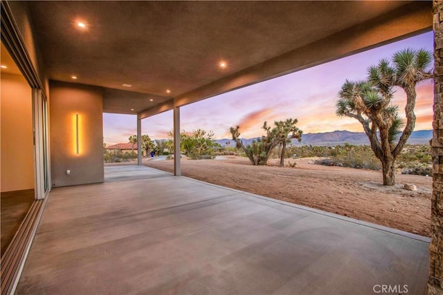 patio terrace at dusk with a mountain view