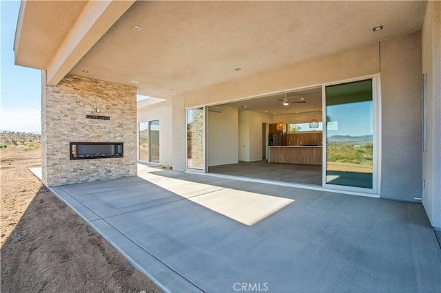 view of patio / terrace with an outdoor stone fireplace