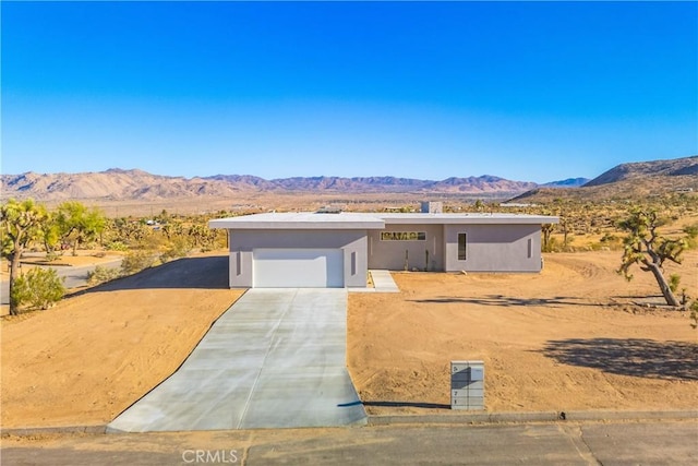 view of front of home featuring a mountain view and a garage