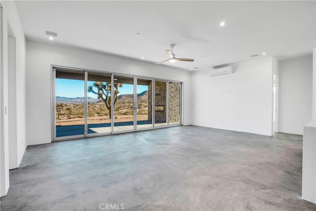 unfurnished room with ceiling fan, concrete floors, plenty of natural light, and an AC wall unit