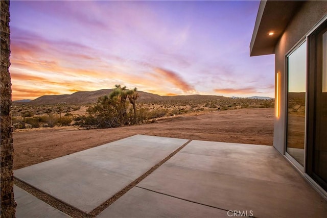 patio terrace at dusk with a mountain view