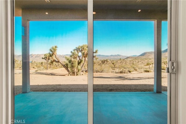 entryway featuring concrete floors and a mountain view