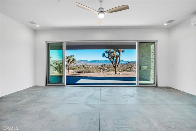 empty room with concrete floors and ceiling fan