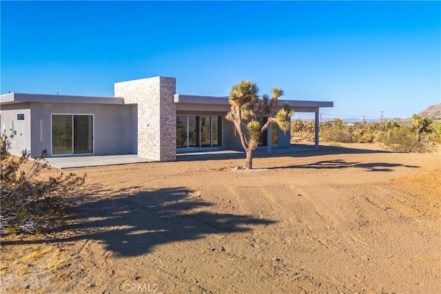 rear view of property featuring a patio