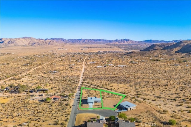 birds eye view of property featuring a mountain view