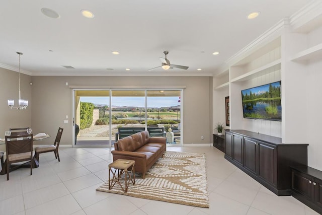 living room with light tile patterned floors, ornamental molding, and ceiling fan with notable chandelier