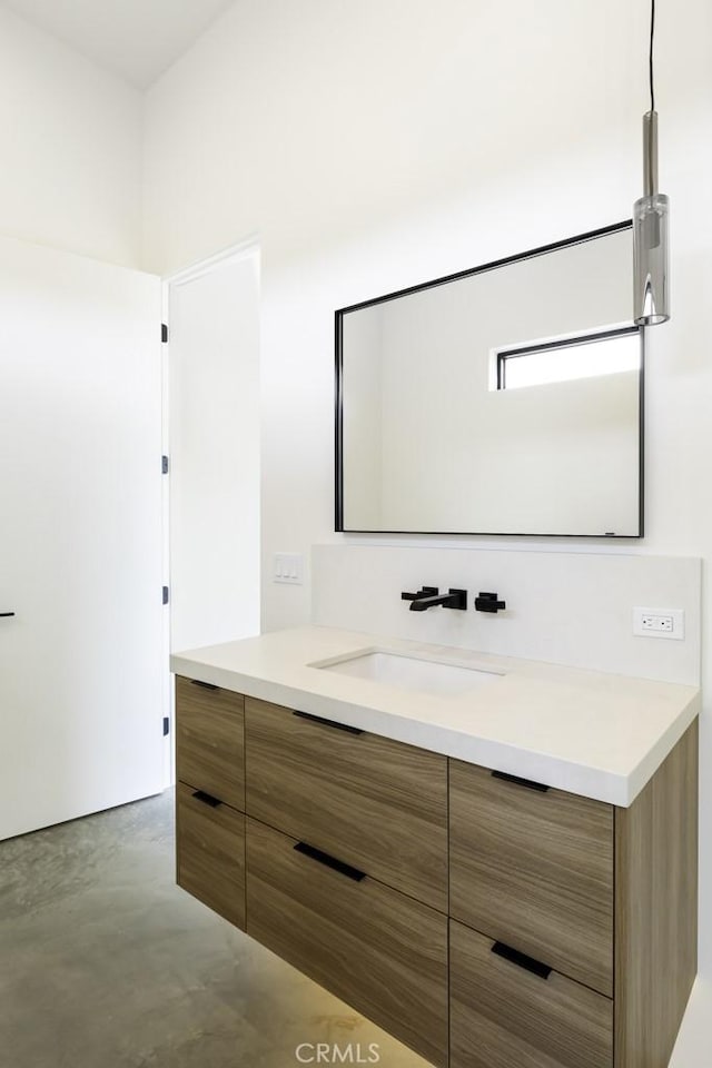 bathroom with vanity and concrete flooring