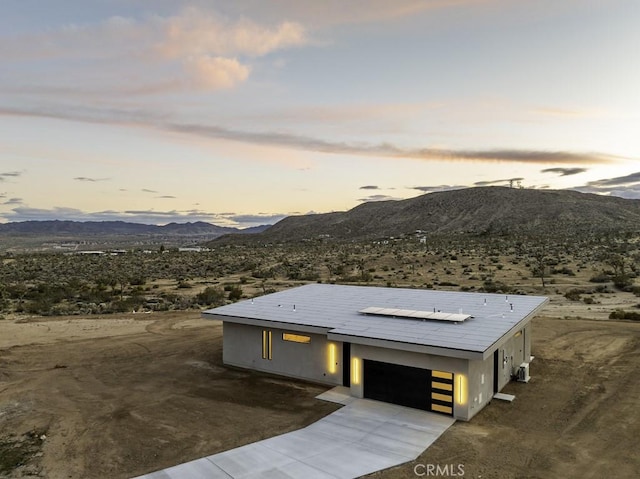 view of front of property with a mountain view and a garage