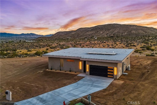 view of front of home with a mountain view and a garage