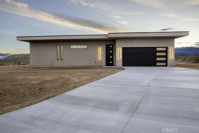 contemporary home with a mountain view and a garage