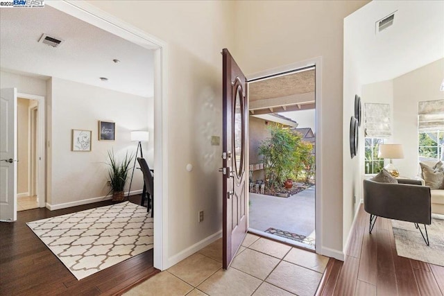 foyer entrance with light hardwood / wood-style floors