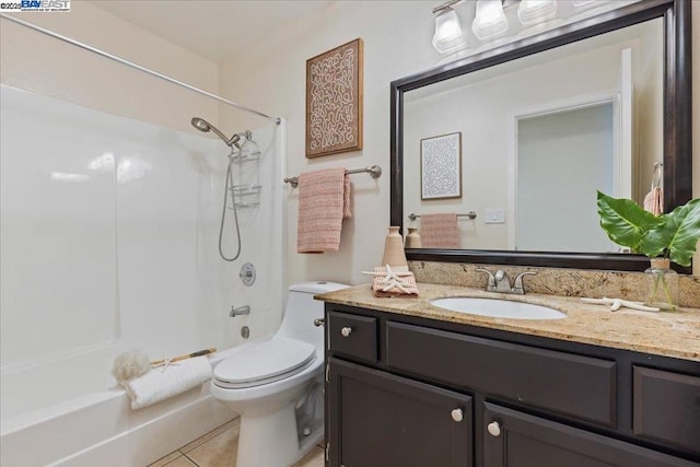 full bathroom with washtub / shower combination, tile patterned floors, toilet, and vanity