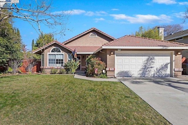 view of front of home with a garage and a front yard