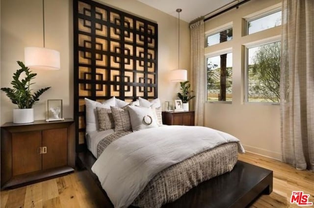 bedroom with light hardwood / wood-style floors