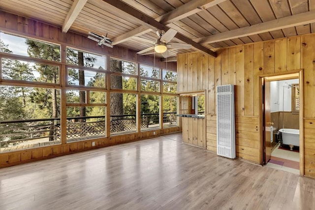 unfurnished sunroom featuring ceiling fan and beamed ceiling