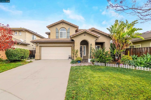 mediterranean / spanish-style home featuring a front yard and a garage