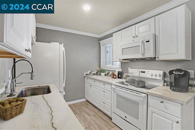 kitchen with sink, crown molding, white appliances, light hardwood / wood-style flooring, and white cabinets