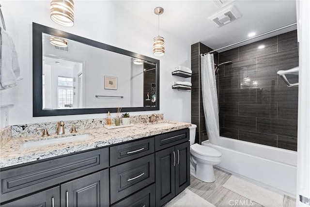 full bathroom featuring toilet, vanity, and shower / bath combo