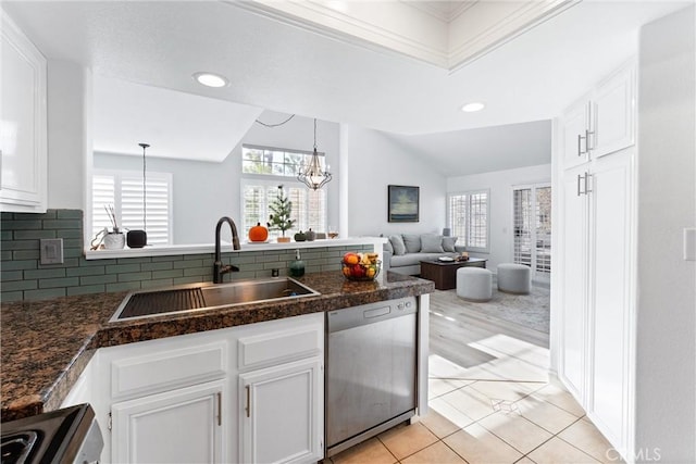 kitchen with stainless steel dishwasher, white cabinetry, and pendant lighting