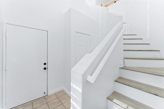 stairs featuring tile patterned floors