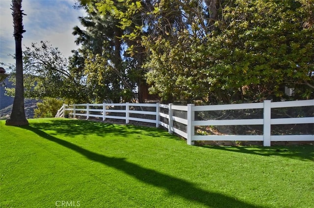 view of gate featuring a yard