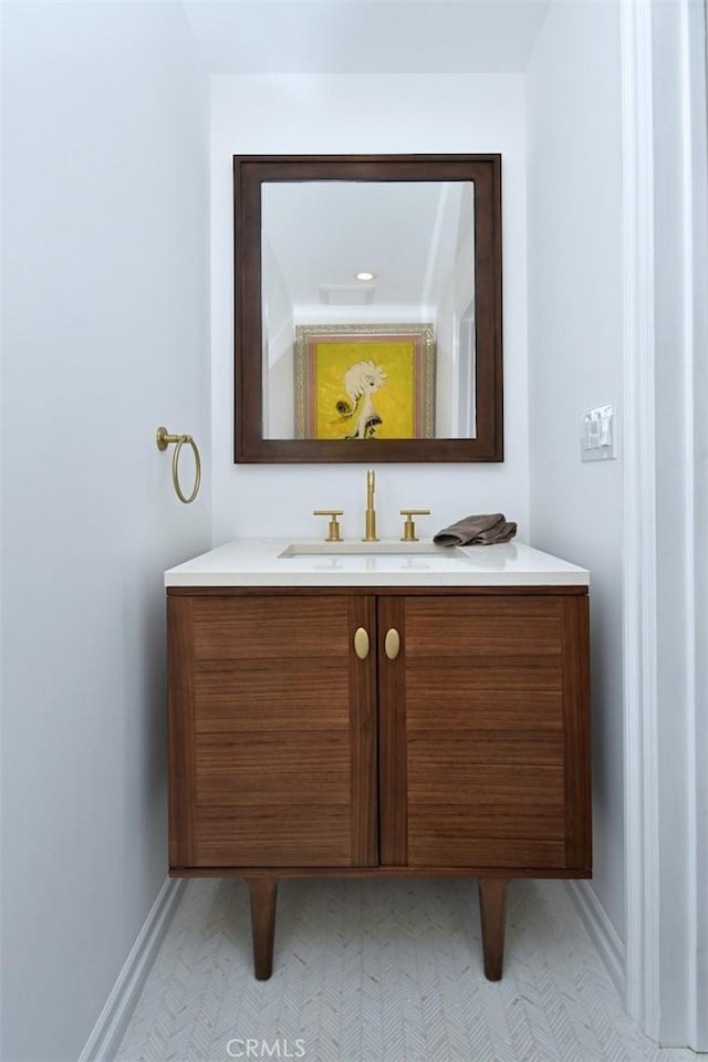 bathroom with vanity and baseboards