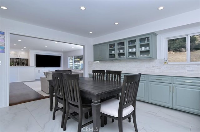 dining space featuring recessed lighting and marble finish floor