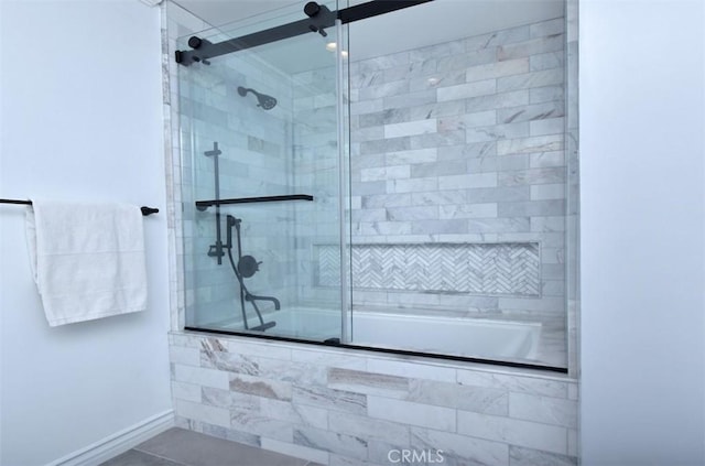 bathroom with shower / bath combination with glass door