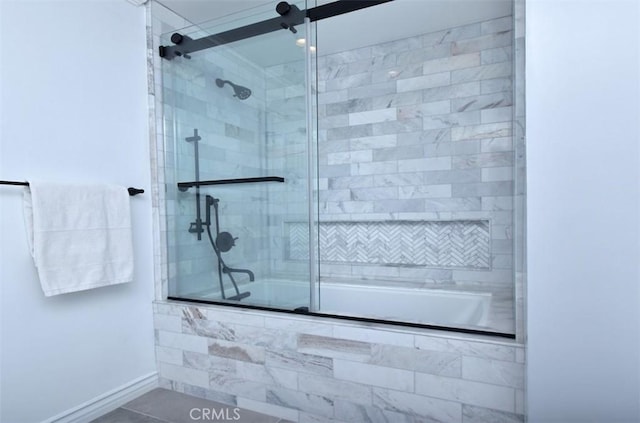 full bath featuring tiled shower / bath combo, baseboards, and tile patterned floors