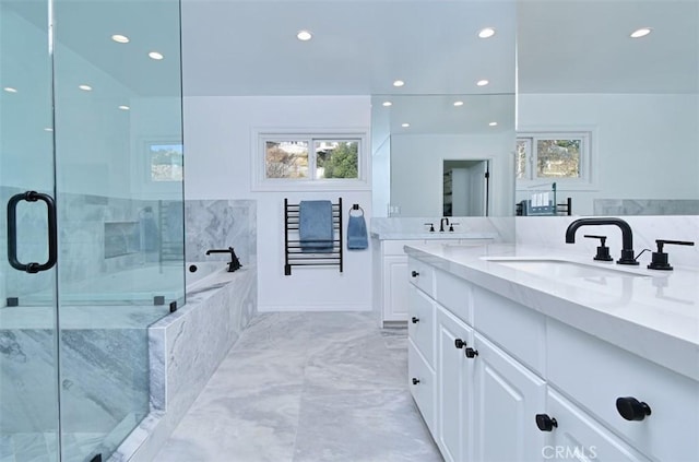 bathroom featuring vanity and shower with separate bathtub