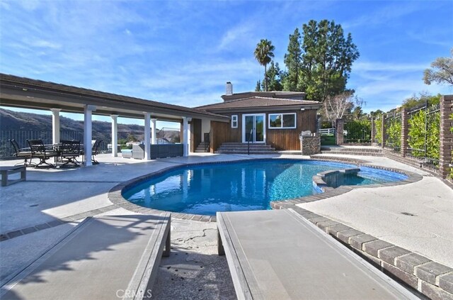 view of pool featuring a patio and an outdoor structure