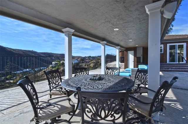 view of patio / terrace with an outdoor hangout area and a mountain view